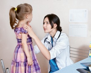 The doctor examines the child