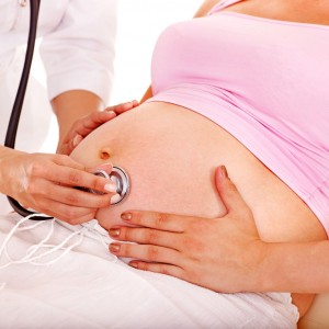 Pregnant woman with doctor .