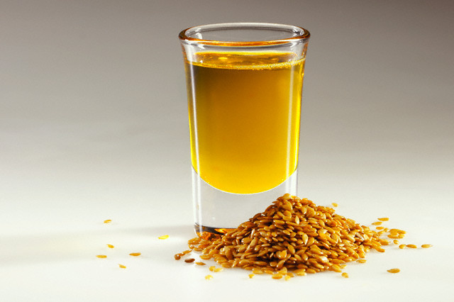 Flax Seeds and Cup of Flax Seed Oil